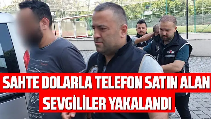 Sahte dolarla telefon satın alan sevgililer yakalandı