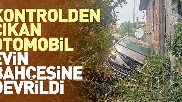 Otomobil evin bahçesine devrildi