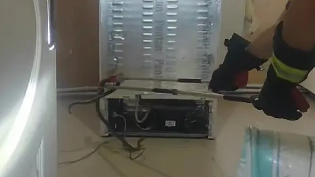 Buzdolabı motoruna giren yılanı itfaiye çıkardı